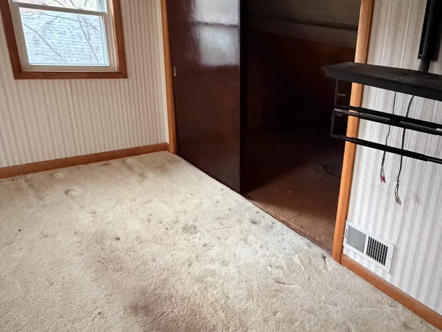 The same room empty and broom-swept after The Junk Heroes estate cleanout