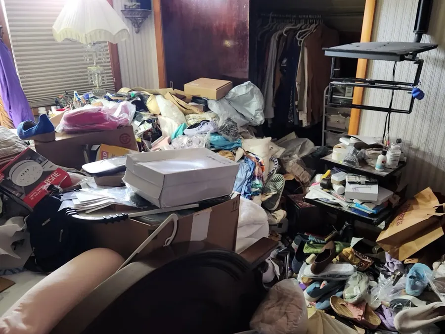 Room in a North Shore, MA home packed wall to wall with belongings before The Junk Heroes estate cleanout